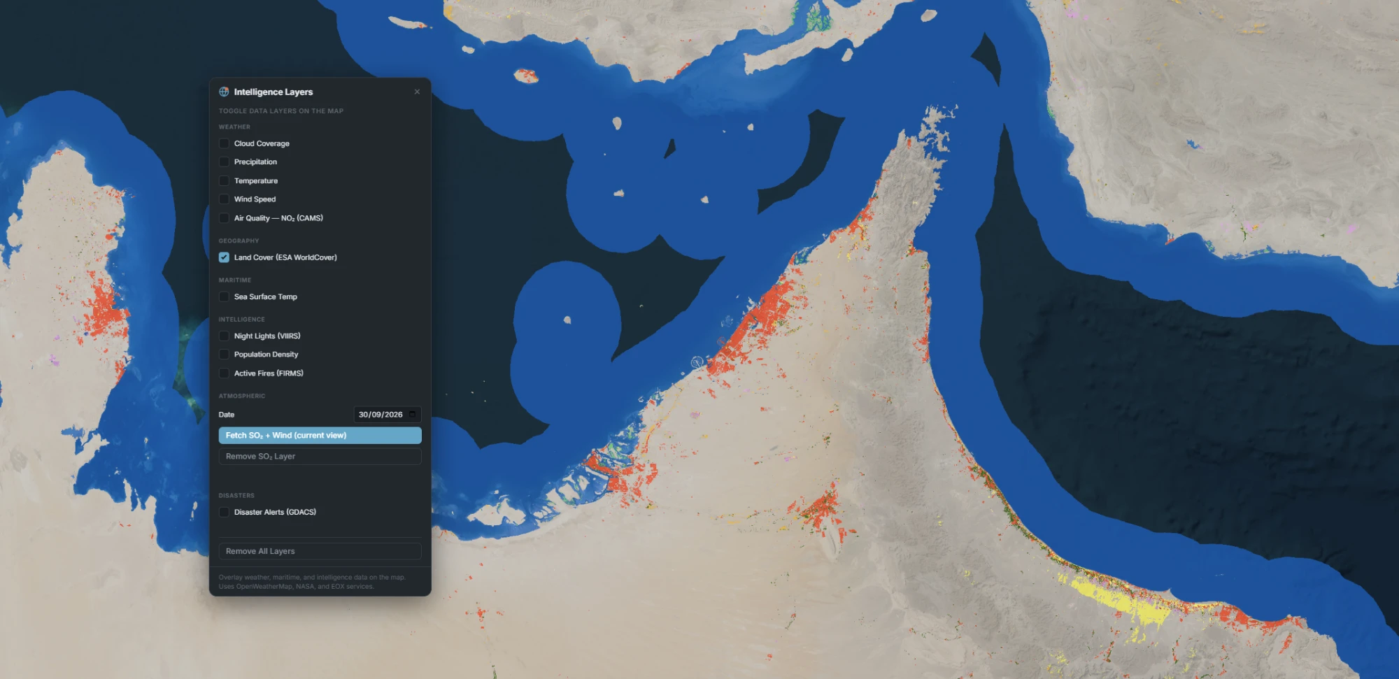 ESA WorldCover land-cover classification draped over the United Arab Emirates coastline near Dubai and Abu Dhabi, showing built-up areas in red, bare desert in beige, sparse vegetation in yellow-green, and the Persian Gulf and Gulf of Oman in blue, with the Intelligence Layers panel open showing Land Cover checked.